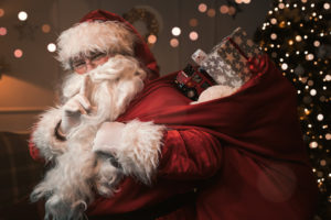 Santa clause holding his finger to his mouth