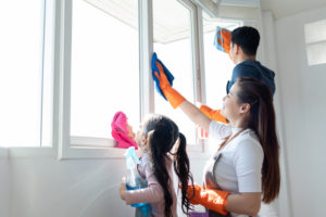 Kids cleaning a home window