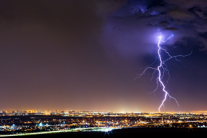 lightning striking over a city