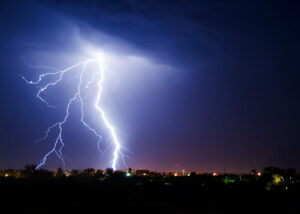 lightning strikes during a storm in a residential neighborhood