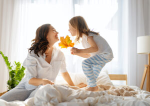 girl and mother enjoying sunny morning