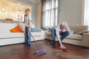 father and son cleaning floor