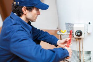 technician performing water heater repair