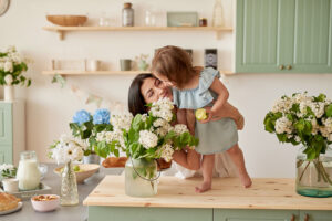 mother hugging daughter inside their home