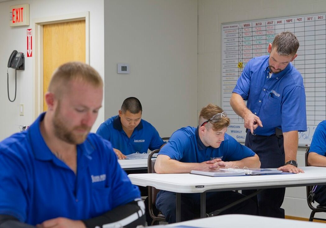 technicians learning in John Betlem HVAC's training facility